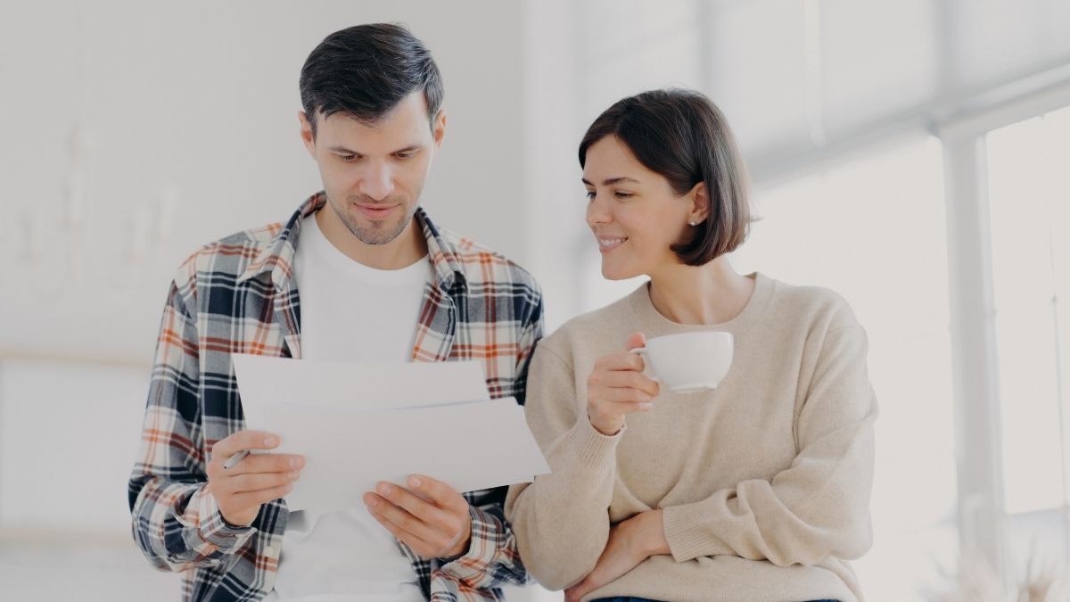 Couple reviewing documents together at home, symbolizing comparison of Medicare Supplement options including high deductible Plan G coverage.