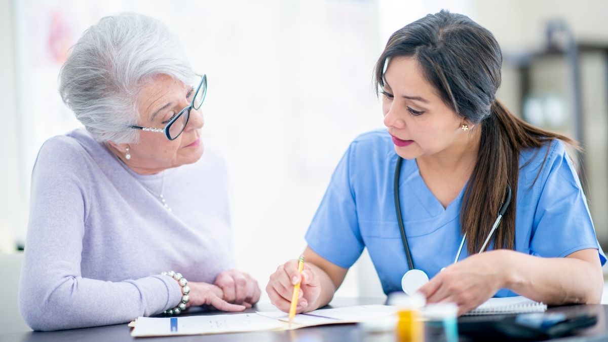 Healthcare professional explaining coverage options to a senior woman, representing AARP Medicare Supplement plans.