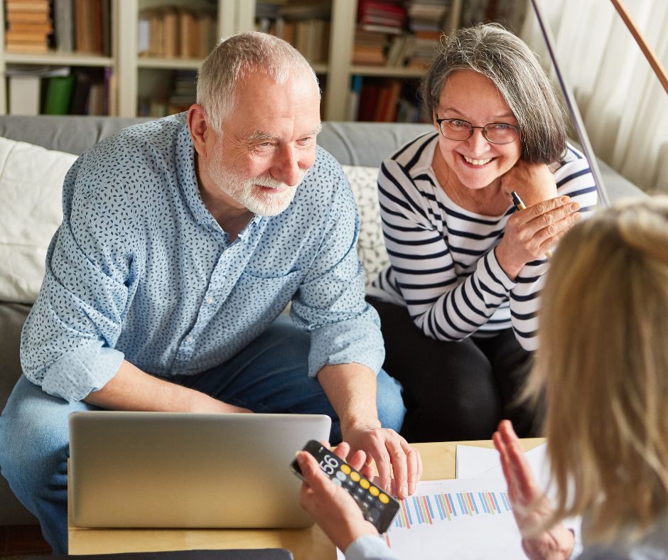 Older couple discussing Medicare Advantage plans with a Medigap advisor and smiling