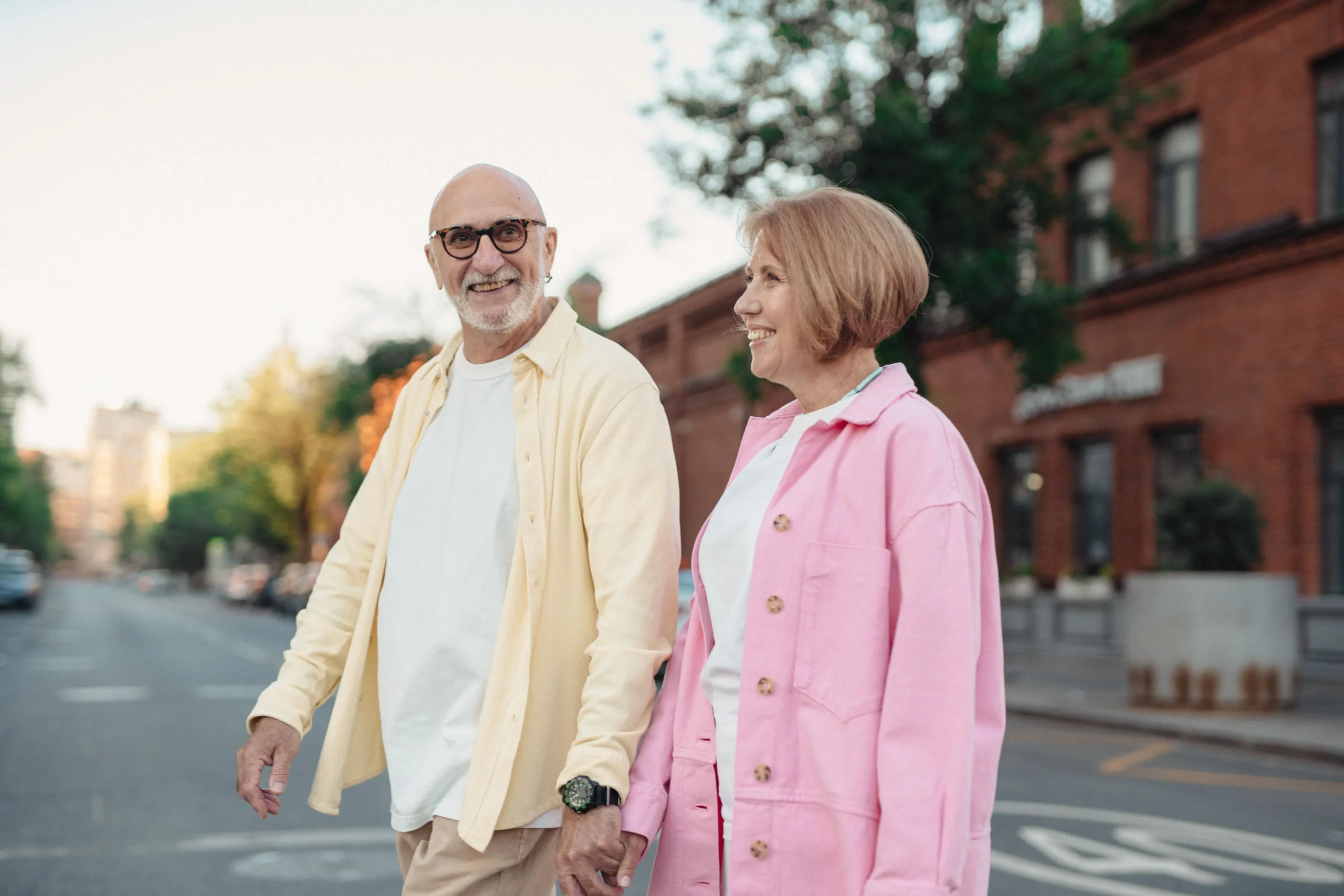 Husband and wife holding hands crossing the steet